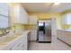 Bright kitchen with stainless steel refrigerator and ample counter space at 106 Silverbell Ct, Sun City Center, FL 33573