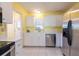 Bright kitchen featuring stainless steel appliances and tile flooring at 106 Silverbell Ct, Sun City Center, FL 33573