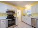 Bright kitchen featuring white cabinets and stainless steel appliances at 106 Silverbell Ct, Sun City Center, FL 33573