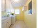 Bright laundry room with storage cabinets and a utility sink at 106 Silverbell Ct, Sun City Center, FL 33573