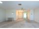 Spacious living room with carpet, ceiling fan, and neutral paint ready for personalization at 106 Silverbell Ct, Sun City Center, FL 33573