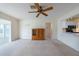 Living room with ceiling fan and open access to the kitchen and eat-in nook at 106 Silverbell Ct, Sun City Center, FL 33573