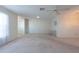 Spacious living room featuring neutral paint, ceiling fan, and carpet at 106 Silverbell Ct, Sun City Center, FL 33573