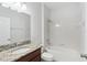 Bathroom featuring vanity with granite top and shower-tub combo with white tile at 1119 Ballard Green Pl, Brandon, FL 33511