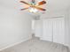 Bedroom featuring neutral walls, plush carpet and a ceiling fan with a large closet at 1119 Ballard Green Pl, Brandon, FL 33511