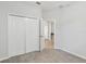 Bedroom features a neutral color palette, closet and connecting door to another room at 1119 Ballard Green Pl, Brandon, FL 33511