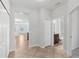 Hallway with tile flooring leading to the living area and a bathroom at 1119 Ballard Green Pl, Brandon, FL 33511