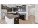Modern kitchen with dark cabinets, granite countertops, stainless steel appliances, and ample counter space at 1119 Ballard Green Pl, Brandon, FL 33511