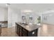 Stylish kitchen featuring a center island with a sink, dark cabinetry, and stainless steel appliances at 1119 Ballard Green Pl, Brandon, FL 33511