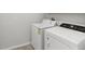 Well-lit laundry room featuring a white washer and dryer at 1119 Ballard Green Pl, Brandon, FL 33511