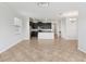 Bright, open living area featuring tile floors and a seamless flow to the kitchen at 1119 Ballard Green Pl, Brandon, FL 33511