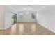 Bright living room with large windows, sliding glass doors, and tile flooring, perfect for entertaining at 1119 Ballard Green Pl, Brandon, FL 33511