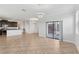 Open-concept living space with neutral tile flooring and sliding doors to the patio at 1119 Ballard Green Pl, Brandon, FL 33511