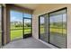 Relaxing patio with views of a lush green lawn and a picturesque building in the background at 1119 Ballard Green Pl, Brandon, FL 33511