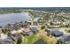 Scenic aerial view showcasing a serene lake community, with lush greenery and beautiful homes, offering a tranquil lifestyle at 11322 Lake Lucaya Dr, Riverview, FL 33579