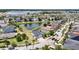 Beautiful aerial view of a neighborhood with a pond and lush landscaping, showcasing a charming home with a brick driveway at 11322 Lake Lucaya Dr, Riverview, FL 33579