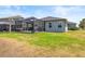Spacious backyard with lush green grass and a screened lanai, perfect for relaxation and entertaining at 11322 Lake Lucaya Dr, Riverview, FL 33579