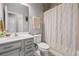 Clean and functional bathroom with a single vanity, toilet, and shower with neutral-toned shower curtain at 11322 Lake Lucaya Dr, Riverview, FL 33579