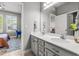 Dual vanity bathroom with modern fixtures, spacious mirrors, and a view into the attached bedroom at 11322 Lake Lucaya Dr, Riverview, FL 33579