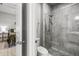 Modern bathroom with tiled shower and glass door, adjacent to the bedroom at 11322 Lake Lucaya Dr, Riverview, FL 33579