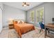Cozy bedroom with comfortable bed, stylish rug, and plenty of natural light from the large windows at 11322 Lake Lucaya Dr, Riverview, FL 33579