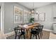 Bright dining room featuring a wooden table, stylish chandelier, and natural light streaming through plantation shutters at 11322 Lake Lucaya Dr, Riverview, FL 33579
