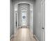 Inviting foyer with a decorative glass front door and neutral wood-look flooring at 11322 Lake Lucaya Dr, Riverview, FL 33579