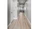 Hallway features wood flooring and white trim at 11322 Lake Lucaya Dr, Riverview, FL 33579