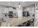 Modern kitchen boasts granite countertops, stainless steel appliances, and a spacious island with seating at 11322 Lake Lucaya Dr, Riverview, FL 33579
