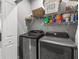 A well-equipped laundry room with modern washer, dryer, and shelving for storage at 11322 Lake Lucaya Dr, Riverview, FL 33579