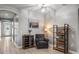 Inviting living room featuring a comfortable armchair, stylish decor, and an elegant arched doorway at 11322 Lake Lucaya Dr, Riverview, FL 33579