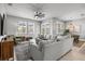 Spacious living room with comfortable seating, natural light, and an open layout connecting to the dining area at 11322 Lake Lucaya Dr, Riverview, FL 33579