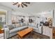 Open-concept living area features a spacious sofa and a view of the modern kitchen at 11322 Lake Lucaya Dr, Riverview, FL 33579