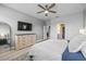 Spacious main bedroom featuring a ceiling fan, ensuite bathroom, and walk-in closet at 11322 Lake Lucaya Dr, Riverview, FL 33579