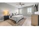 Serene main bedroom with a ceiling fan, wood-look flooring and bright window light at 11322 Lake Lucaya Dr, Riverview, FL 33579