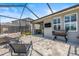 Spacious outdoor patio area with grill, seating, and screened enclosure at 11322 Lake Lucaya Dr, Riverview, FL 33579