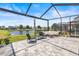 Relaxing screened patio featuring pond views and comfortable outdoor seating at 11322 Lake Lucaya Dr, Riverview, FL 33579