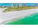 Breathtaking aerial view showcases a pristine white sand beach and turquoise water near luxury beachfront condos at 1200 Gulf Blvd # 404, Clearwater Beach, FL 33767