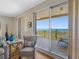 Relaxing chair and stunning views through sliding glass doors leading to the balcony at 1200 Gulf Blvd # 404, Clearwater Beach, FL 33767