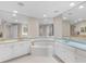 Spacious bathroom with large mirrors, dual sinks, white cabinets, and luxurious soaking tub at 1200 Gulf Blvd # 404, Clearwater Beach, FL 33767