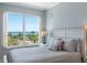 Cozy bedroom featuring serene water views from the window and a comfortable bed at 1200 Gulf Blvd # 404, Clearwater Beach, FL 33767