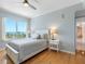 Bright bedroom with a ceiling fan, wood floors, and a scenic view from the large window at 1200 Gulf Blvd # 404, Clearwater Beach, FL 33767