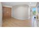 Inviting foyer with wood-look tile flooring, neutral walls, and views to outdoor balcony at 1200 Gulf Blvd # 404, Clearwater Beach, FL 33767