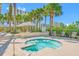 Relaxing hot tub surrounded by lush landscaping and palm trees with lounge seating and shaded cabana at 1200 Gulf Blvd # 404, Clearwater Beach, FL 33767