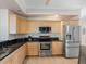Well-equipped kitchen featuring stainless steel appliances and ample cabinet space at 1200 Gulf Blvd # 404, Clearwater Beach, FL 33767