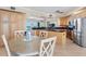 Bright, modern kitchen with stainless steel appliances, a breakfast bar and dining table at 1200 Gulf Blvd # 404, Clearwater Beach, FL 33767