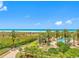 Beautiful ocean view from the property, showcasing the beach and tropical landscaping at 1200 Gulf Blvd # 404, Clearwater Beach, FL 33767