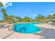Resort-style community pool surrounded by lush landscaping and palm trees with plenty of lounge seating at 1200 Gulf Blvd # 404, Clearwater Beach, FL 33767