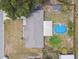 Aerial view of a house featuring a backyard with an above-ground pool and a covered patio area at 12106 Meadow Ln, San Antonio, FL 33576