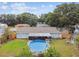Aerial view of the house with an above ground pool at 12106 Meadow Ln, San Antonio, FL 33576